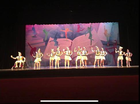 Dancers on orange-lit stage